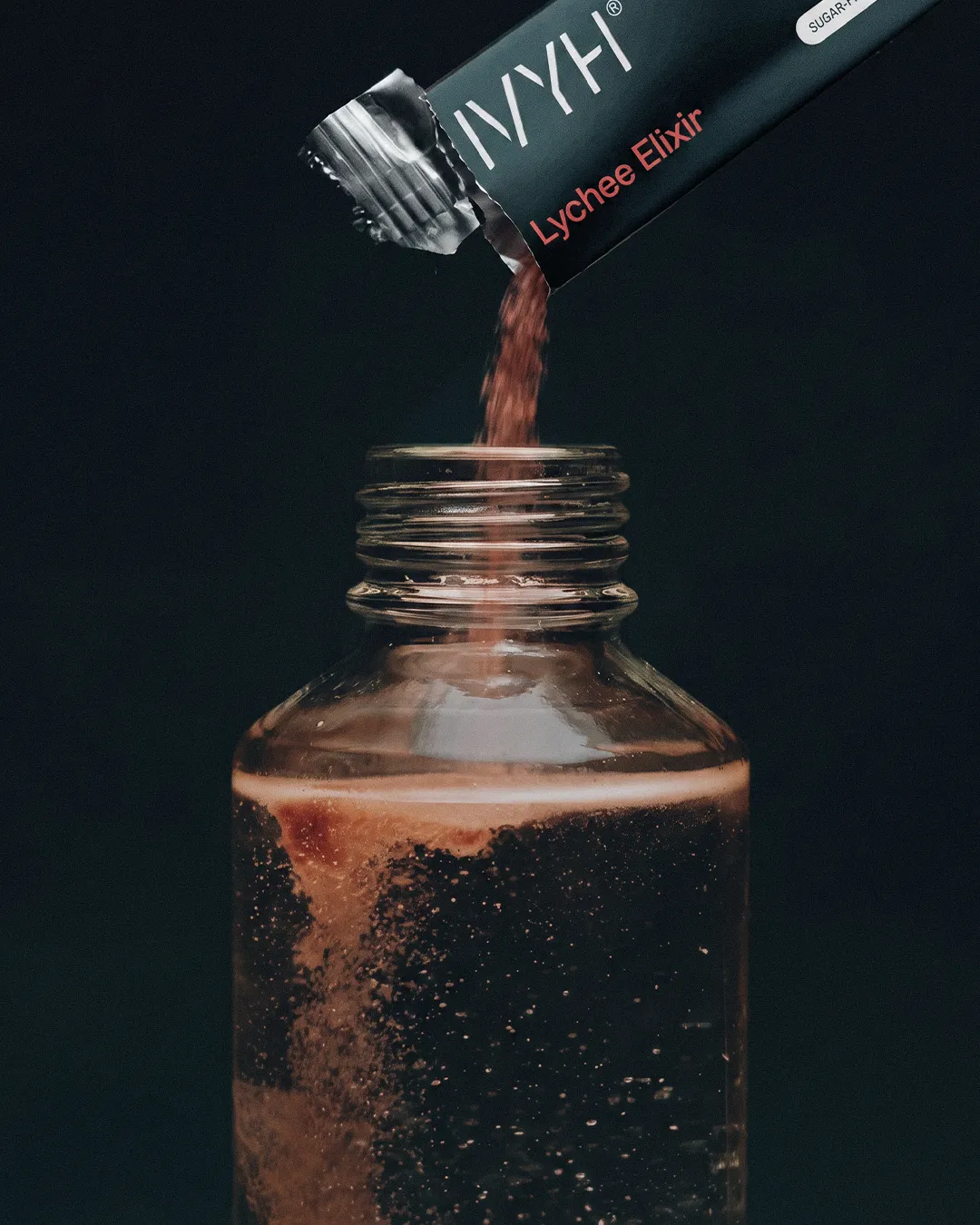 IVYH sachet pouring into a glass jar