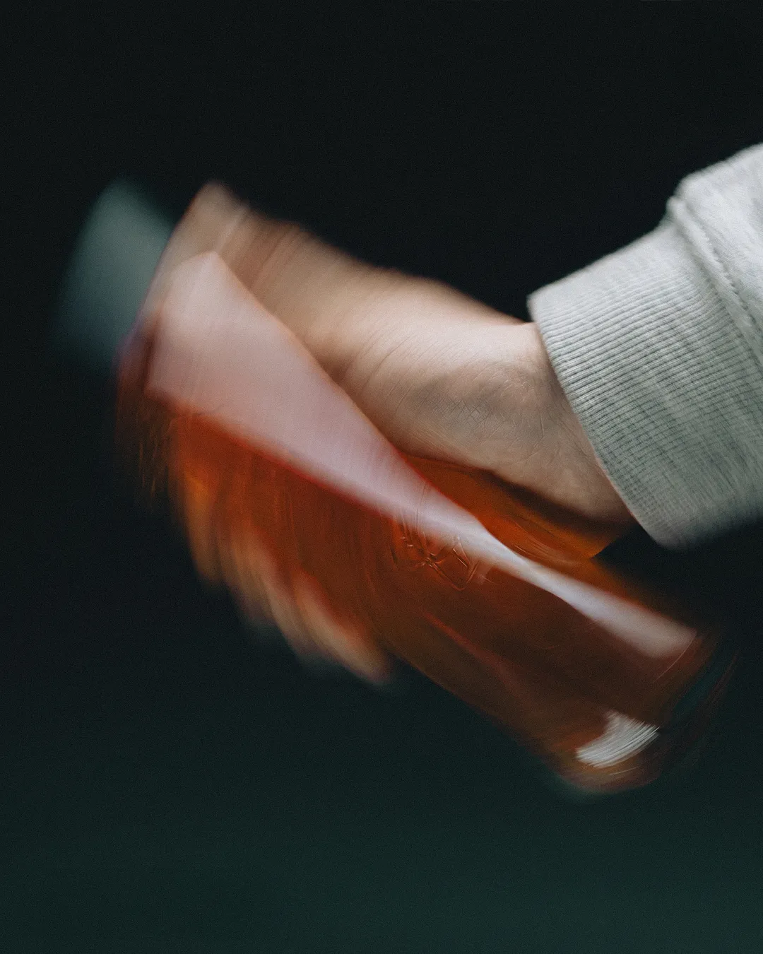 Hand holding an IVYH sachet with motion blur